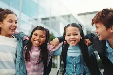 Children happily headed back to school, representing financial learning and student accounts.