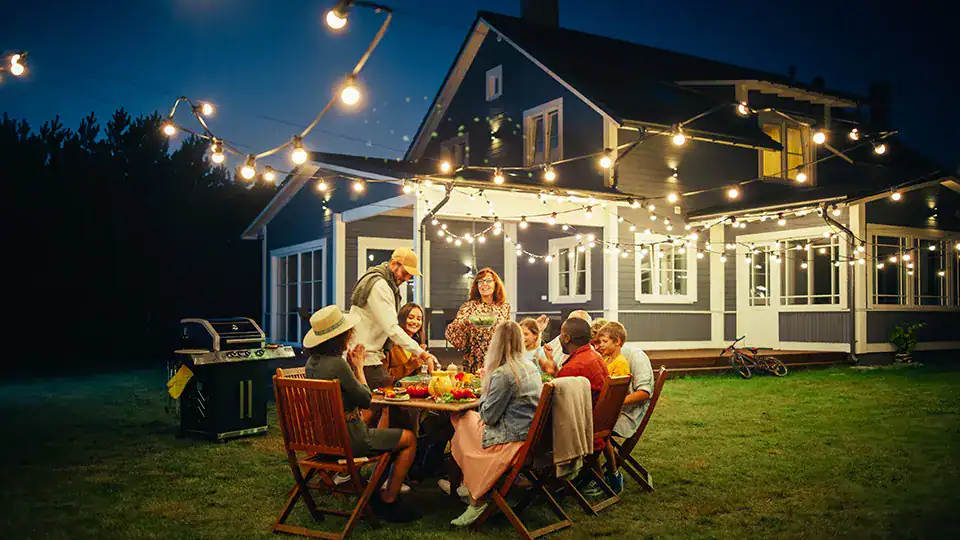 People enjoying outdoor evening gathering while feeling secure in their loan decisions.