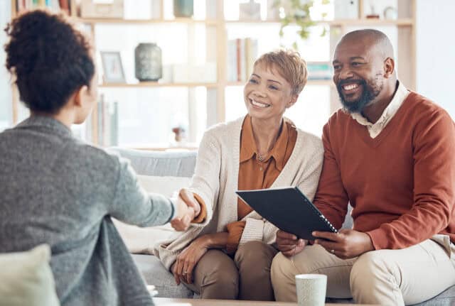 Friendly financial advisor assisting a couple.