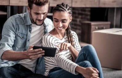 Couple using a smartphone to learn about Digital Service options.