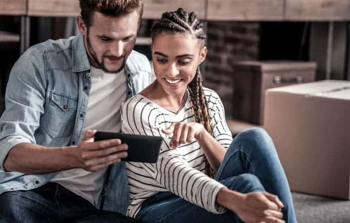 Couple using a smartphone to learn about Digital Service options.