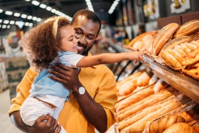 daughter and dad looking at fresh bread