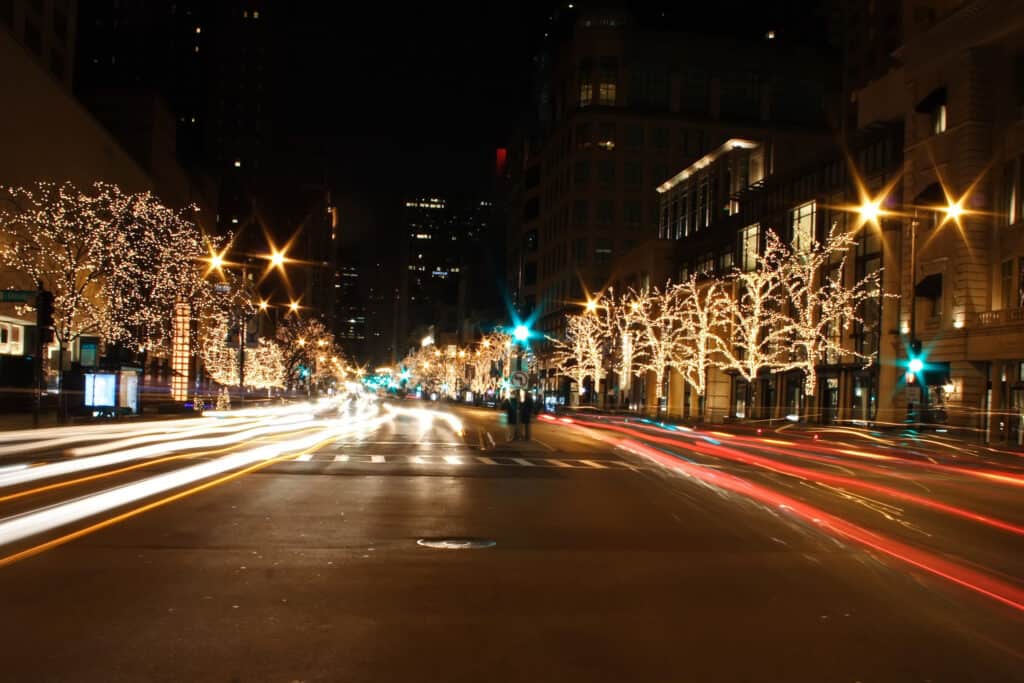 Chicago street lit up at night time with lights in trees
