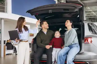 Family receiving car assistance at Educators CU in a dealership setting.