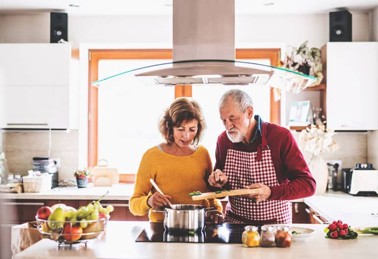 older couple cooking on kitchen