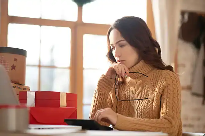 woman budgeting for holiday shopping