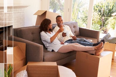 couple on couch surrounded by moving boxes