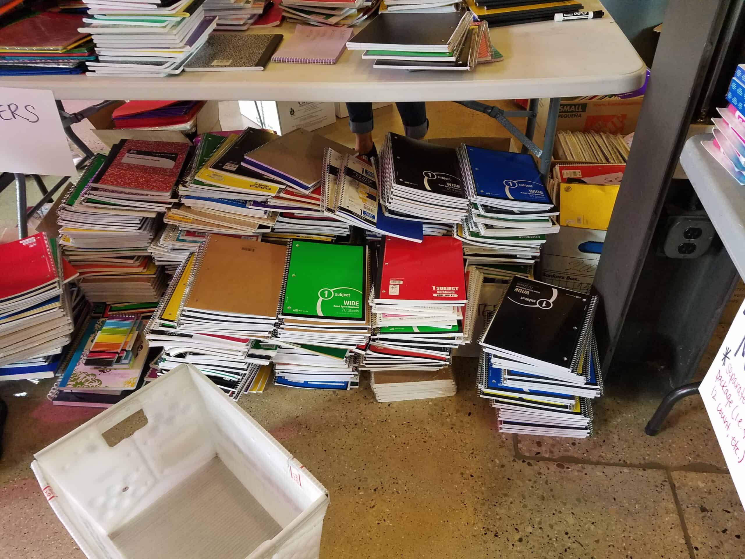 Table full of notebooks for the No Empty Backpack drive
