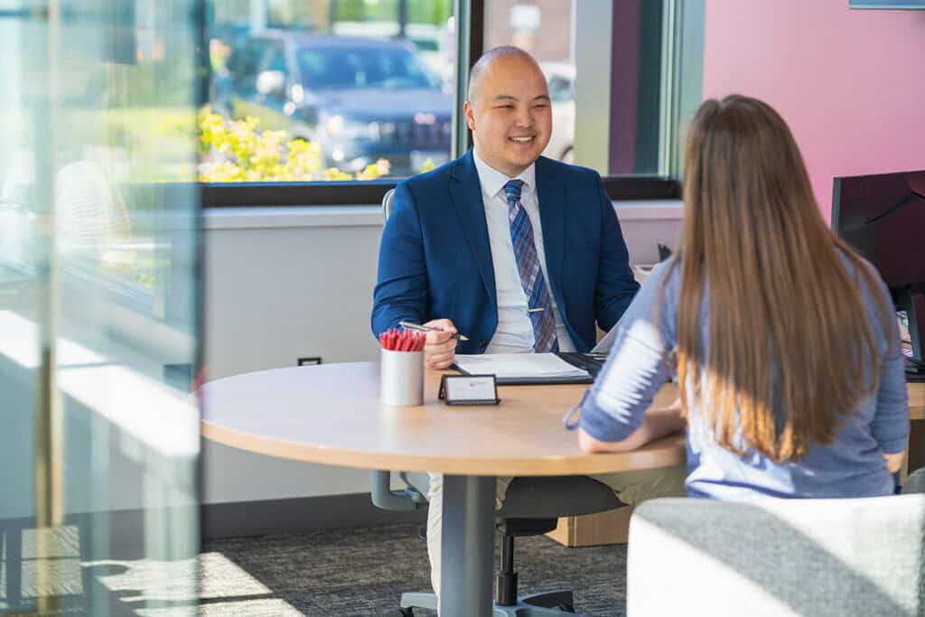 Financial advisor consulting with a client in branch.