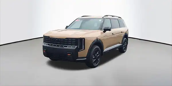 A tan 2026 Kia Telluride car in a showroom casing set as a monthly lease special.