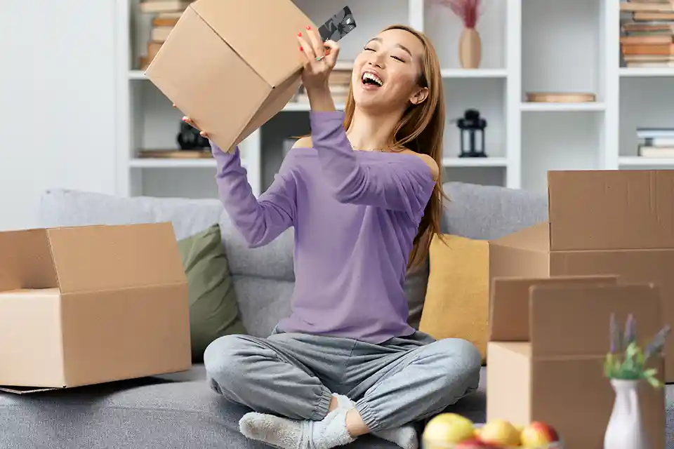 Packing or unpacking moving boxes in a cozy living room.