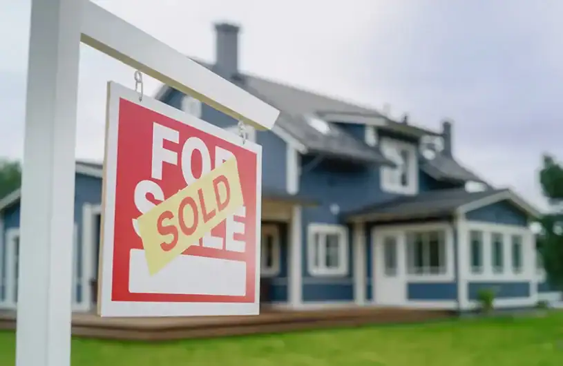 House with 'Sold' sign in front, real estate for sale, residential property with mortgage down payment assistance opportunities.