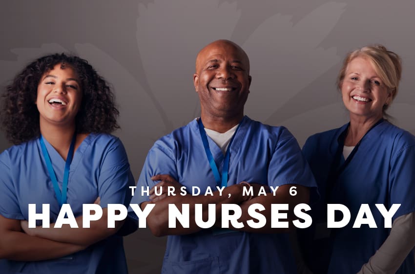 Nurses in blue scrubs smiling