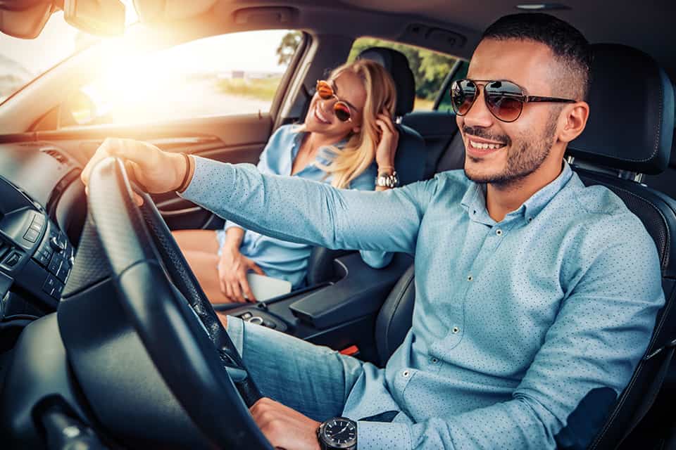 Couple driving new car