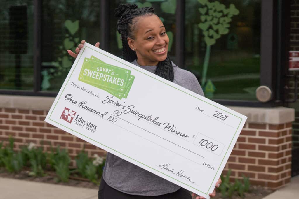 Tiffany holds oversized Saver's Sweepstakes check