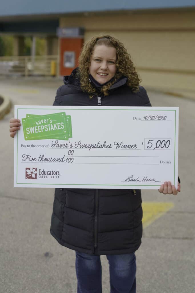 Saver's Sweepstakes Winner Holly B. holds a $5,000 check