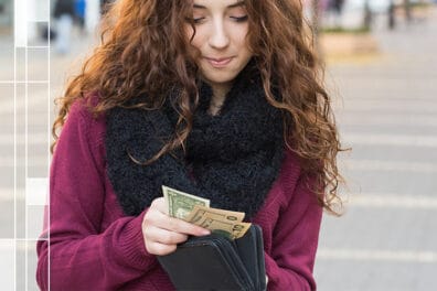 girl with open wallet holding cash