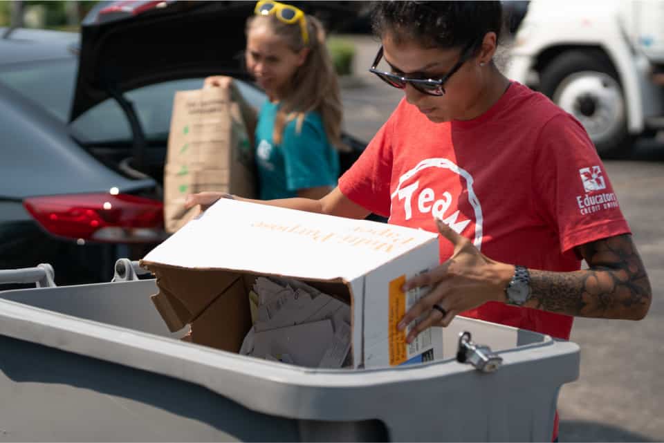 ECU employees holding shred day boxes