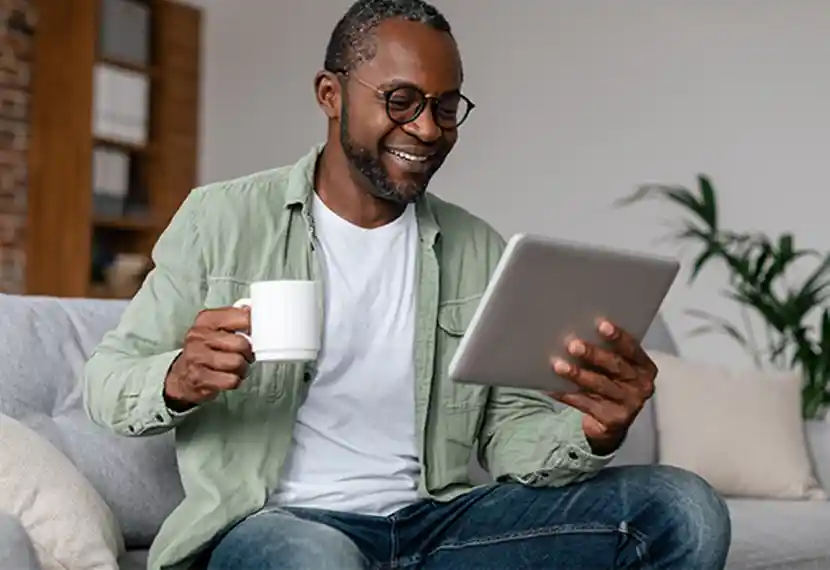 Man with tea and tablet