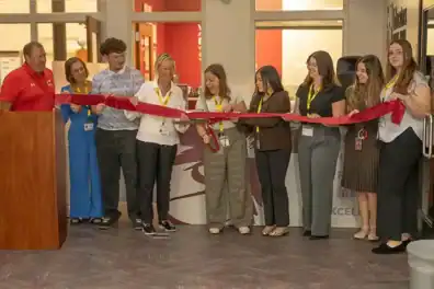 Staff, students, and members at ribbon-cutting event for South Milwaukee High School branch opening.