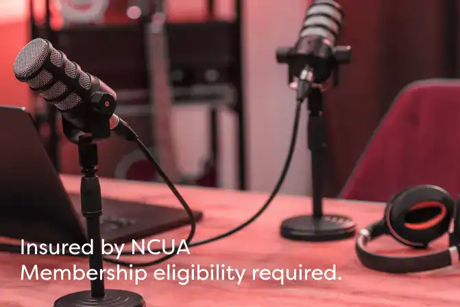 Microphones sitting on table in podcast for Talking Dollars & Sense