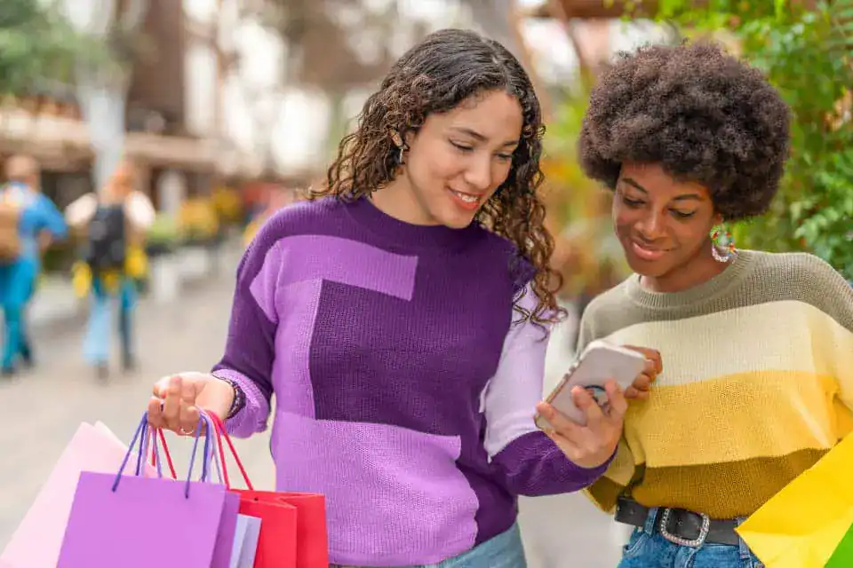 Women shopping using their uChoose Rewards points.
