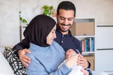 Parents holding and smiling at their baby