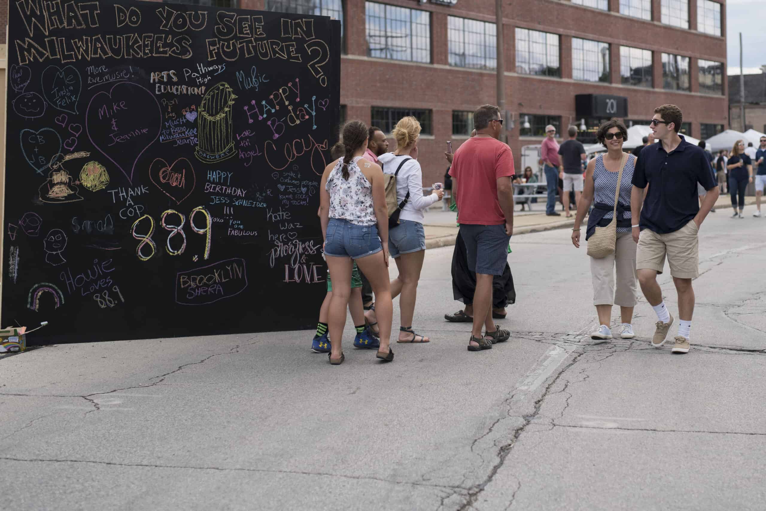 Photo of giant chalkboard asking "What do you see in Milwaukee's Future" at the 88Nine Radio Milwaukee block party