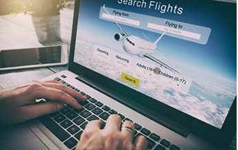 person searching flights on laptop