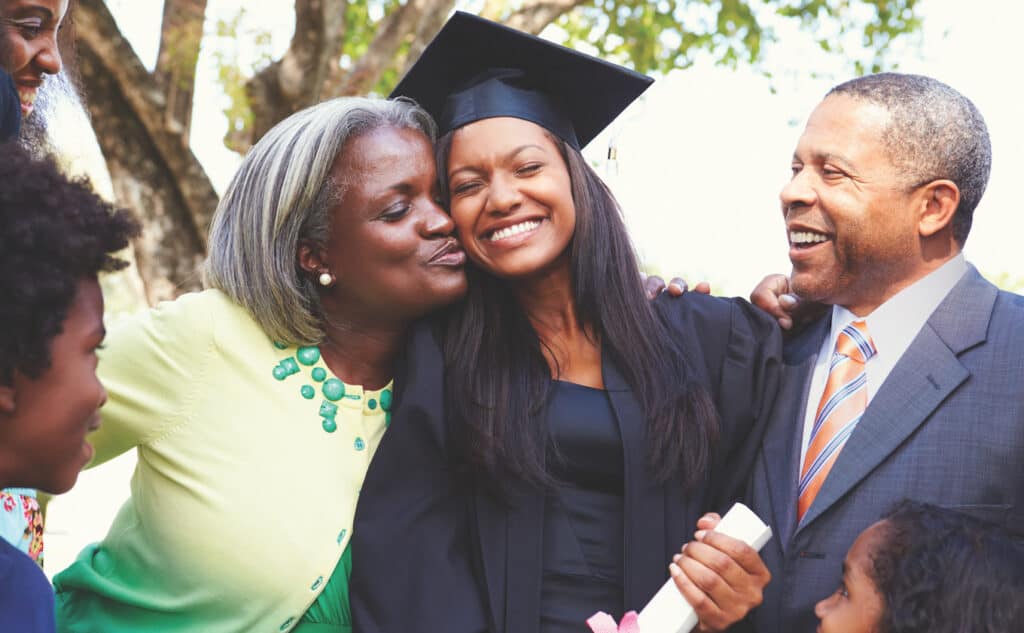 Family surrounding college graduate